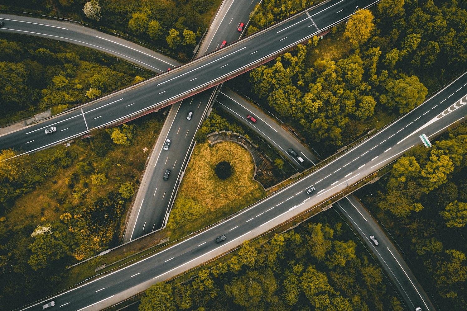 Aerial shot highway overpasses cars driving